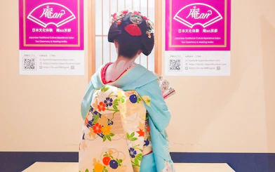 Maiko in traditional kimono at Kyoto tea ceremony venue.