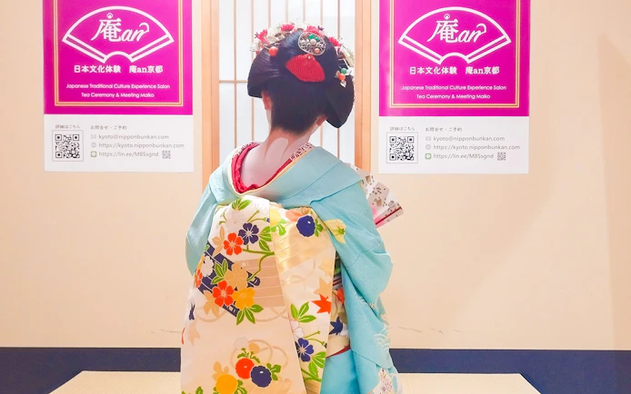 Maiko in traditional kimono at Kyoto tea ceremony venue.
