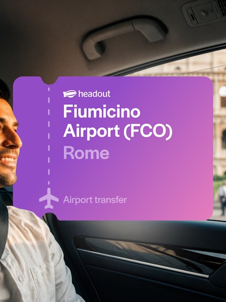 Tourist in cab near Colosseum, Rome with Fiumicino Airport transfer sign.