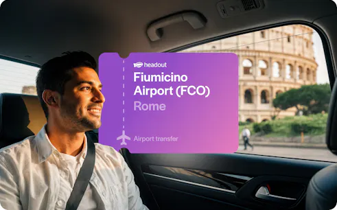 Tourist in cab near Colosseum, Rome with Fiumicino Airport transfer sign.
