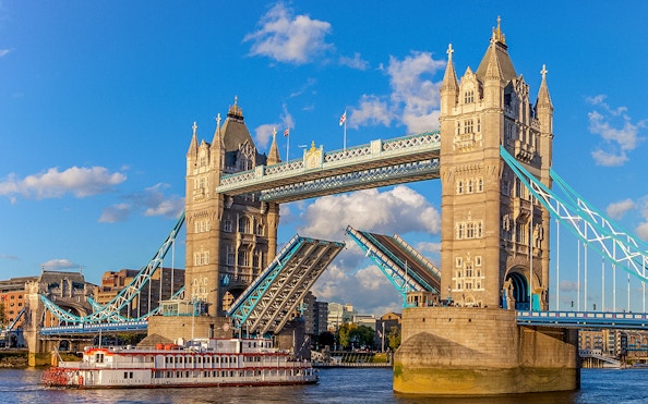 Tower Bridge in London with raised bascules, viewed from the River Thames.