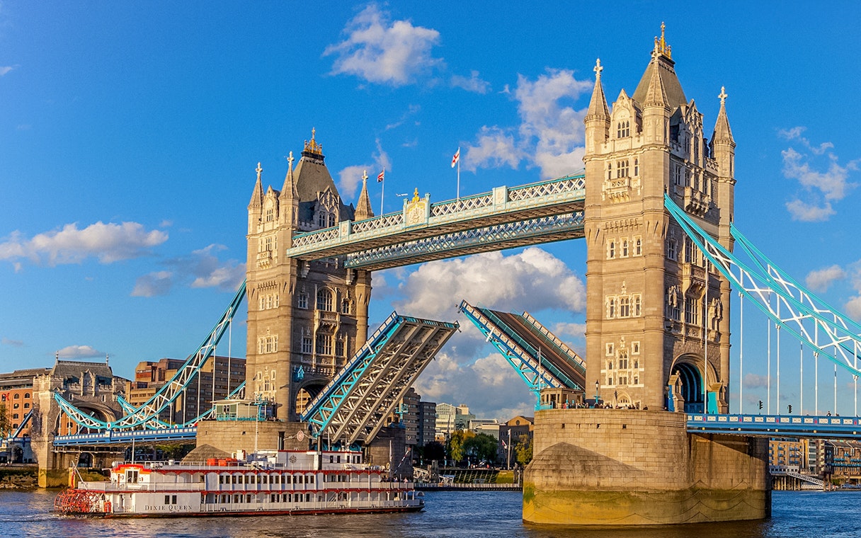 Tower Bridge in London with raised bascules, viewed from the River Thames.
