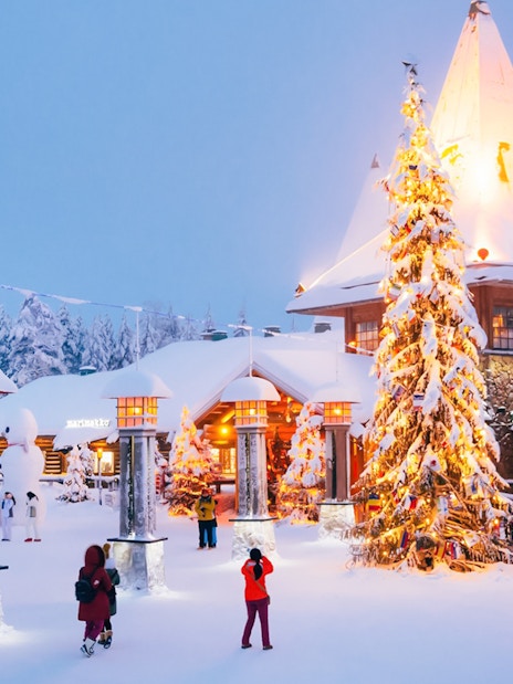 Santa’s Village central plaza with people walking near a decorated Christmas tree.