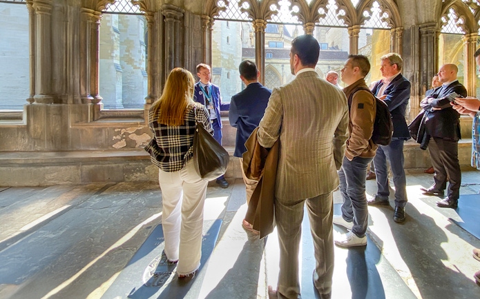 Tourists listening to a guide inside Westminster Abbey, London.