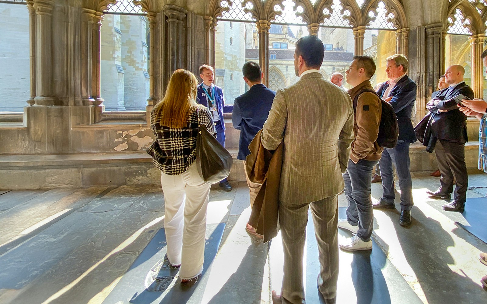 Tourists listening to a guide inside Westminster Abbey, London.