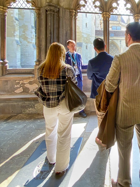 Tourists listening to a guide inside Westminster Abbey, London.