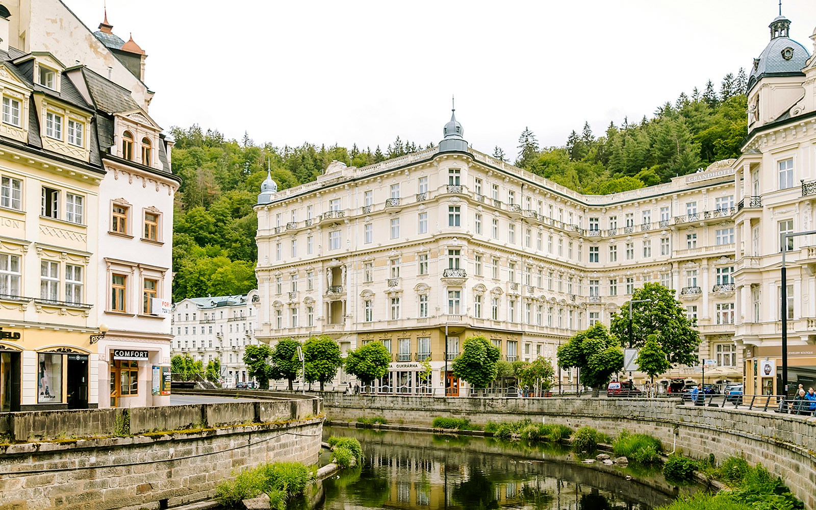Grandhotel Pupp in Karlovy Vary with surrounding historic architecture and lush greenery.