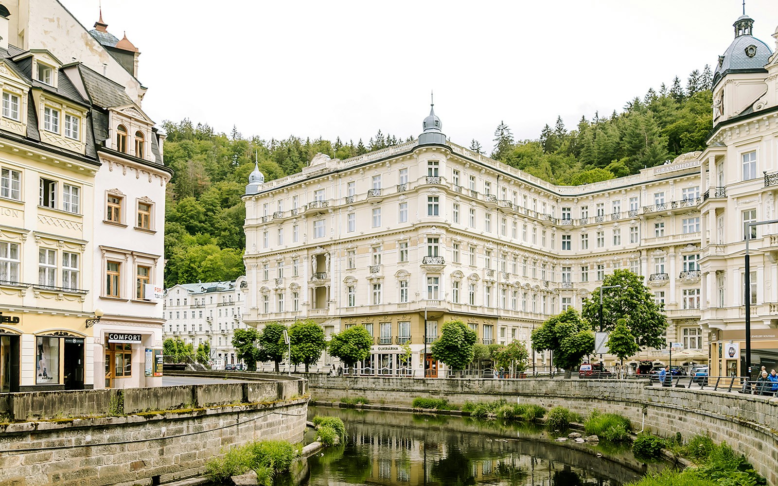 Grandhotel Pupp in Karlovy Vary with surrounding historic architecture and lush greenery.