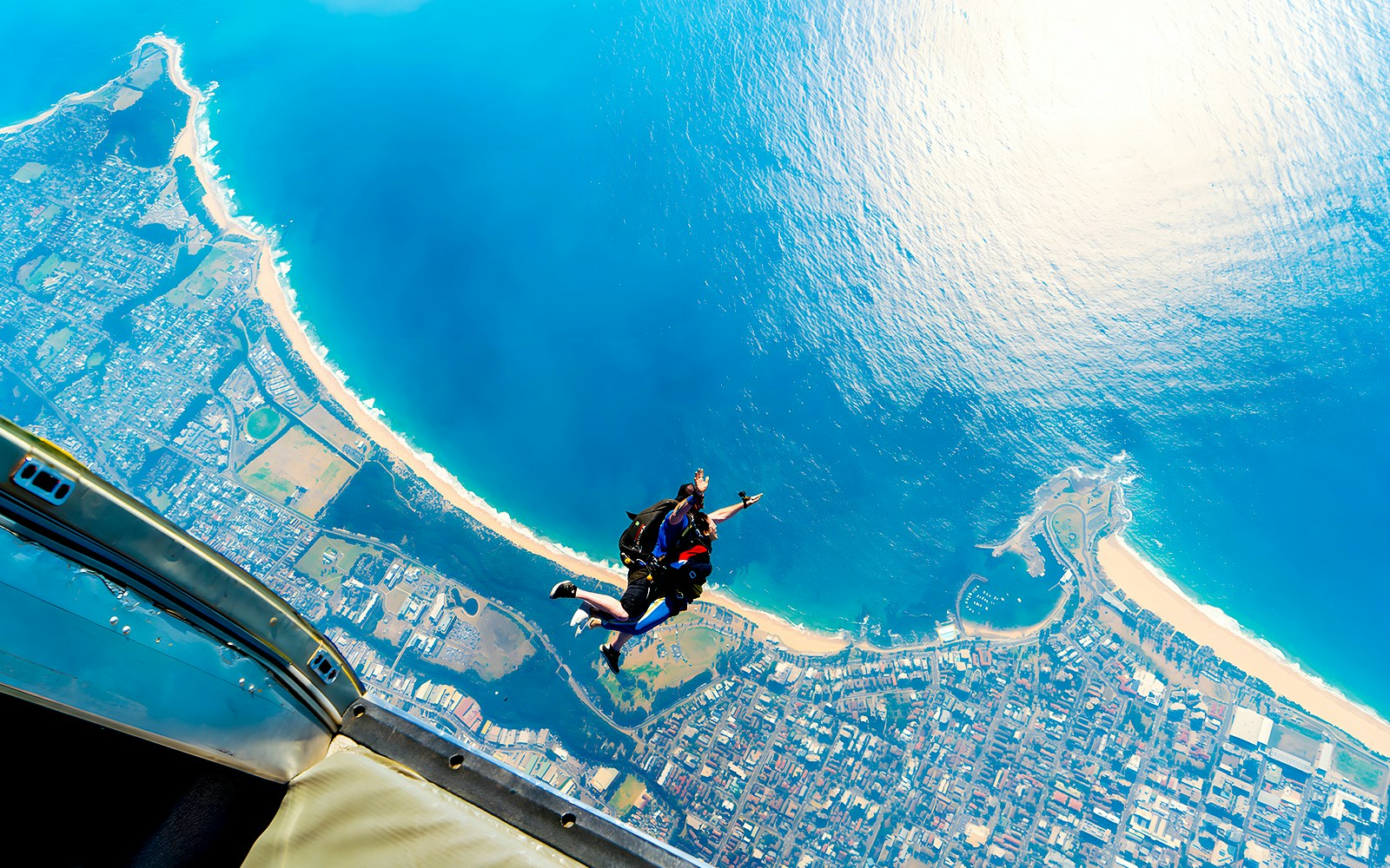 An instructor and a guest skydiving over Wollongong