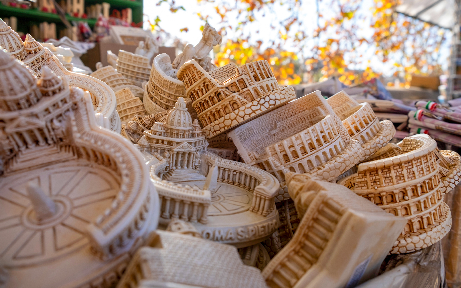 Coliseum and Vatican scaled handmade souvenirs for tourists in a basket on the street of Rome