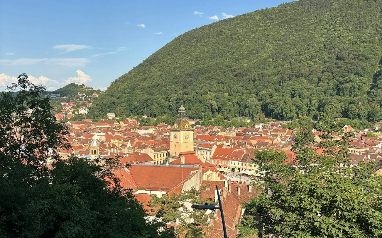 Brasov cityscape with Council House tower and Tampa Mountain in the background.