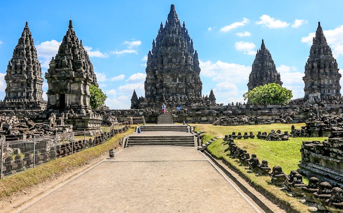 Prambanan Temple complex under a clear sky, part of a guided tour in Indonesia.