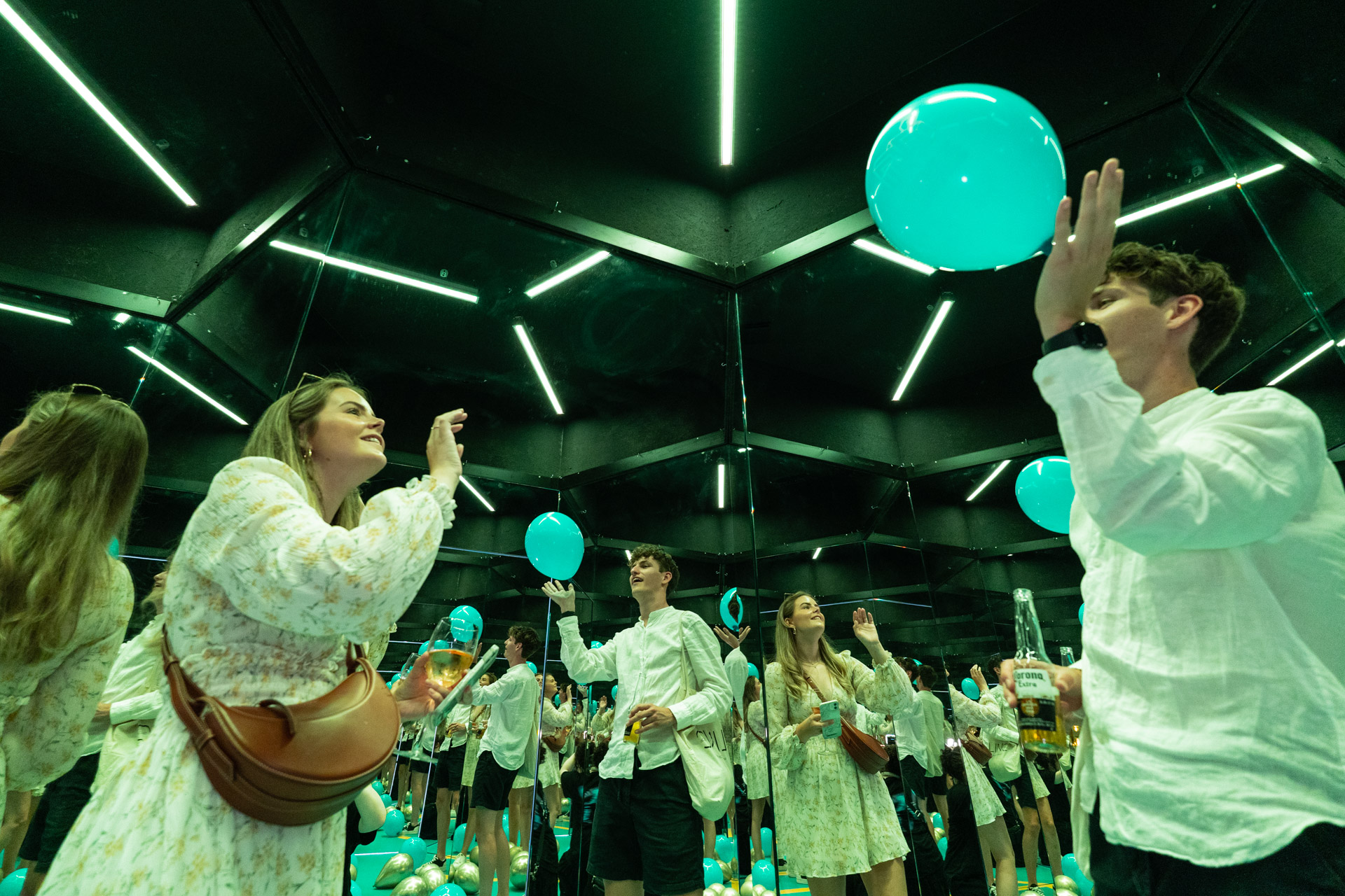 Guests interacting with mirrors and balloons at the Museum of Illusions Amsterdam.