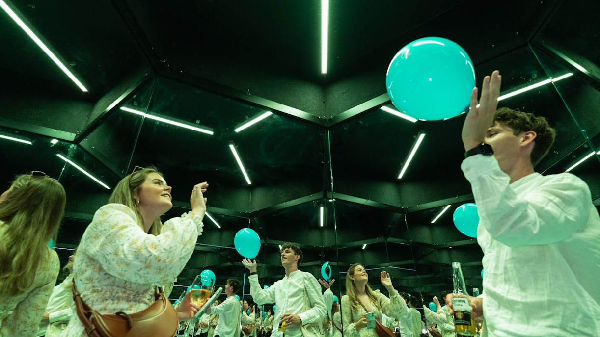 Guests interacting with mirrors and balloons at the Museum of Illusions Amsterdam.