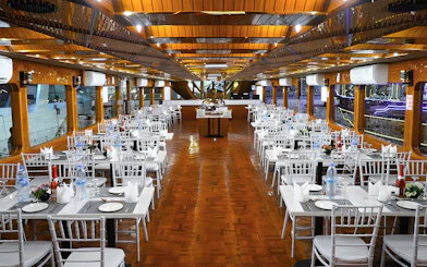 Dining setup on a dhow cruise in Dubai Marina with tables and chairs arranged for dinner.