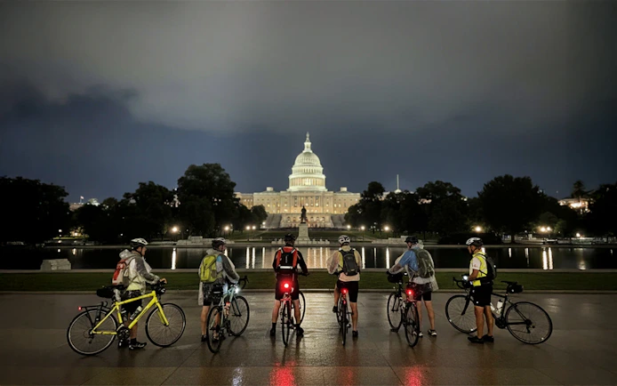 Tourists with bikes in front of the Capitol Building at night, Washington D.C.