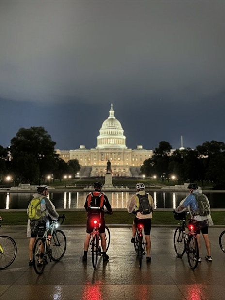 Tourists with bikes in front of the Capitol Building at night, Washington D.C.