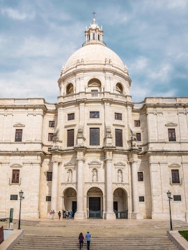 National Pantheon facade in Lisbon with visitors on steps.