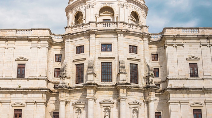 National Pantheon facade in Lisbon with visitors on steps.
