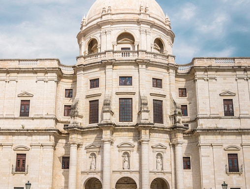National Pantheon facade in Lisbon with visitors on steps.