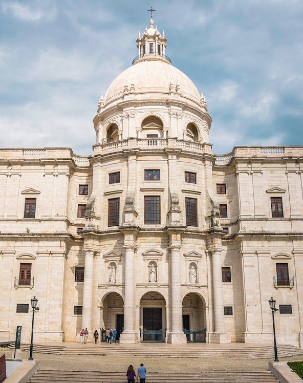 National Pantheon facade in Lisbon with visitors on steps.