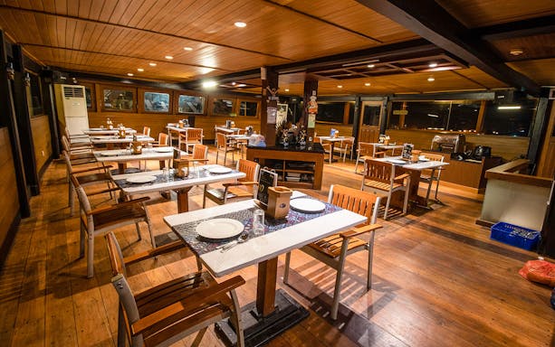 Dining area setup on a pirate-themed dinner cruise ship.