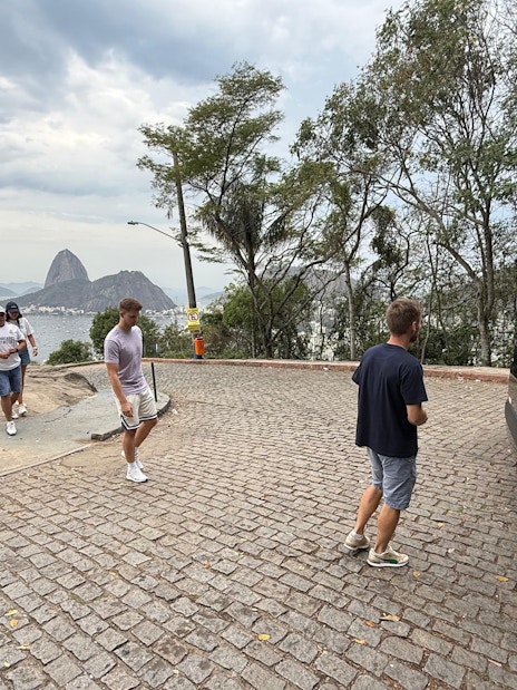 Tourists with guide boarding van at Santa Marta viewpoint, Rio de Janeiro.