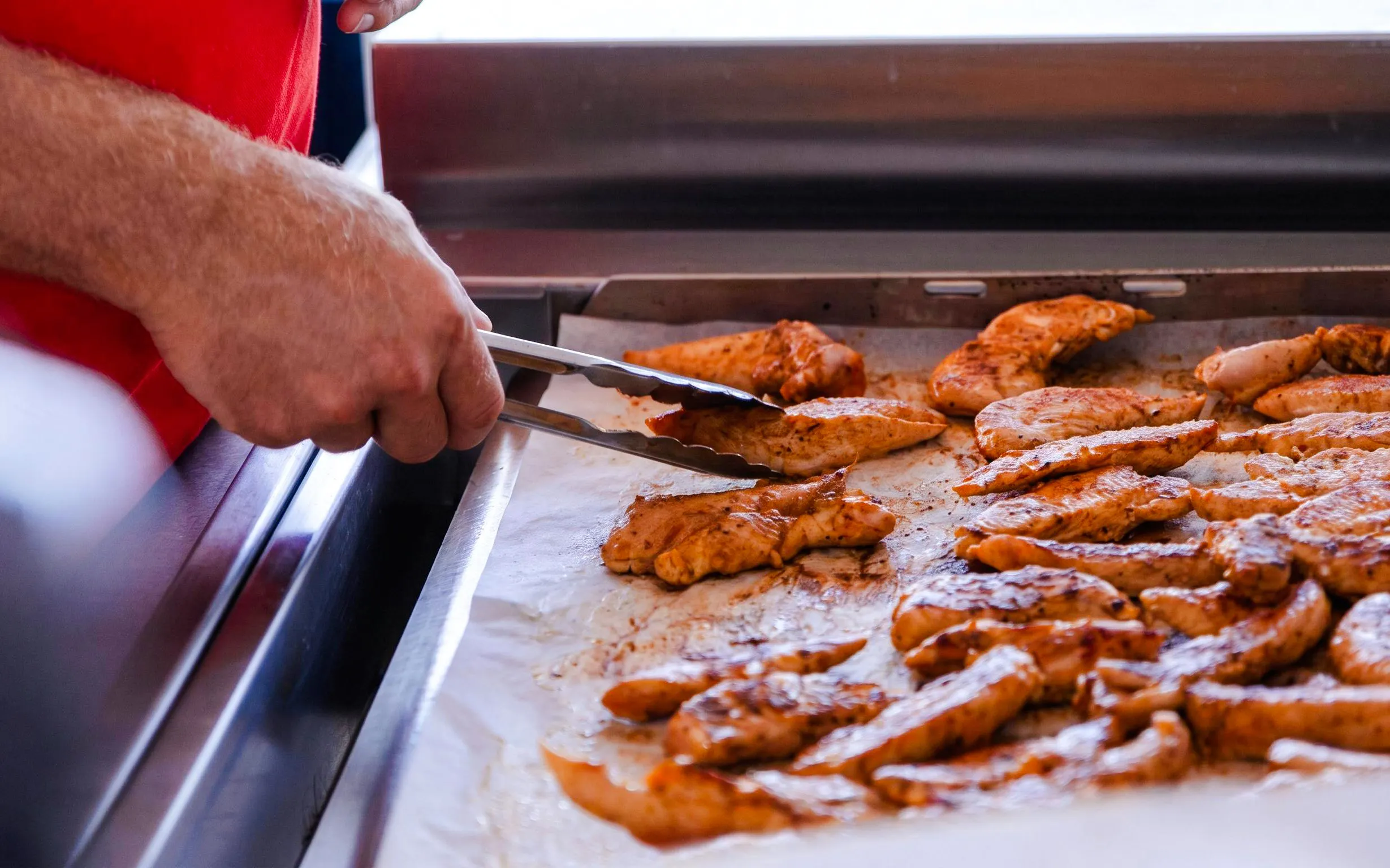 Grilled chicken being prepared on a catamaran cruise near Lérins Island.