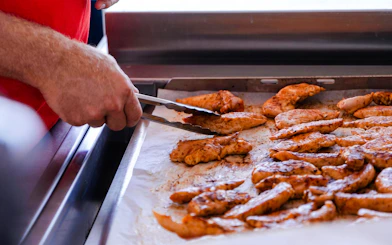 Grilled chicken being prepared on a catamaran cruise near Lérins Island.