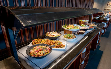 Buffet setup at Te Puia geothermal park featuring traditional Hāngī dishes.