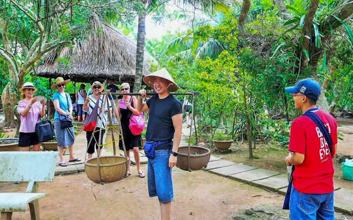 Tourists enjoying a traditional experience in the lush Mekong Delta.
