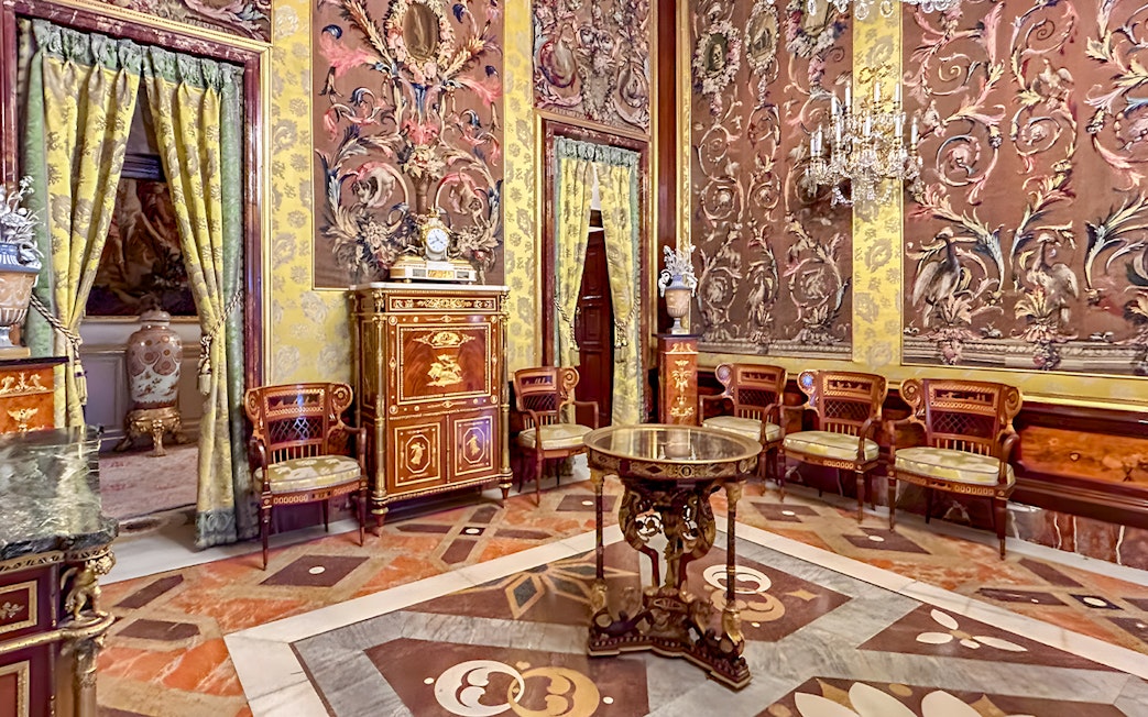Royal Palace of Madrid ornate room with decorative walls and antique furniture.