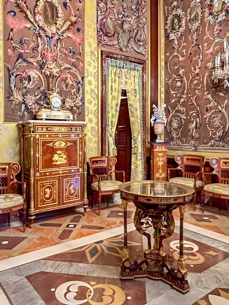 Royal Palace of Madrid ornate room with decorative walls and antique furniture.