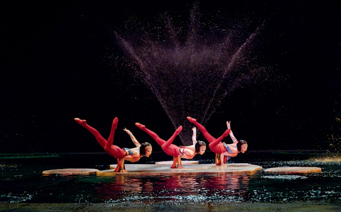 Acrobats performing on water stage in Cirque du Soleil's "O" show, Las Vegas.