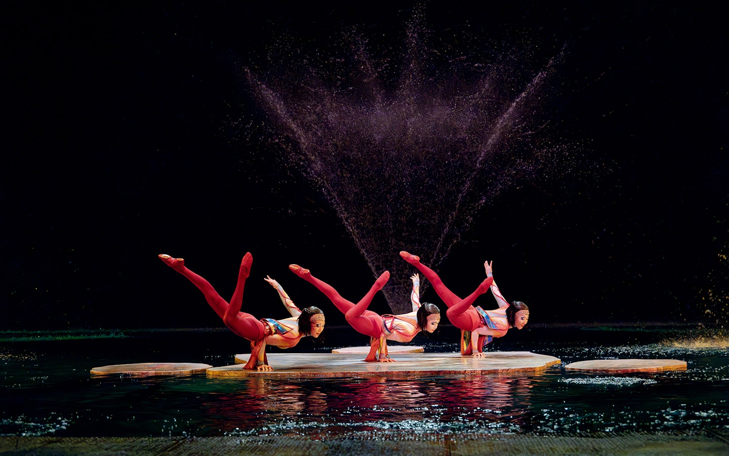 Acrobats performing on water stage in Cirque du Soleil's "O" show, Las Vegas.