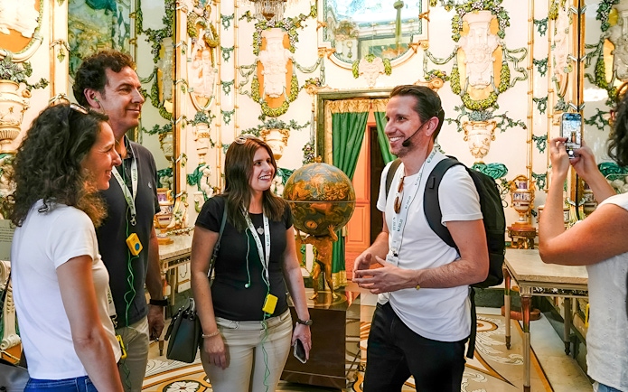 Tour group enjoying a guided visit inside the Royal Palace of Madrid.