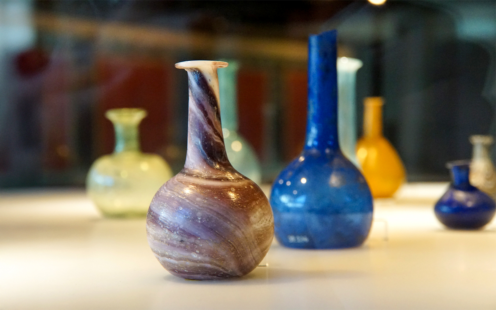 Ancient Roman glass vases displayed in a Venice museum exhibit.