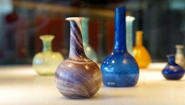 Ancient Roman glass vases displayed in a Venice museum exhibit.