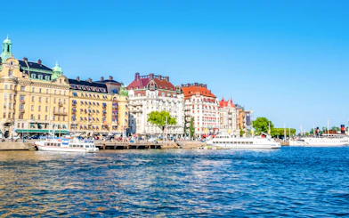 Colorful historic buildings and boats along the waterfront in Ostermalm District, Stockholm.