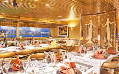 Dining area inside Nova Five Star 2 with elegant table settings and city skyline view.