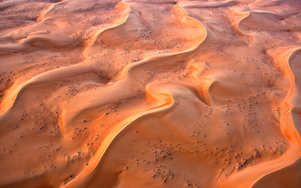 Aerial view of sand dunes in Ras Al Khaimah during a hot air balloon ride.