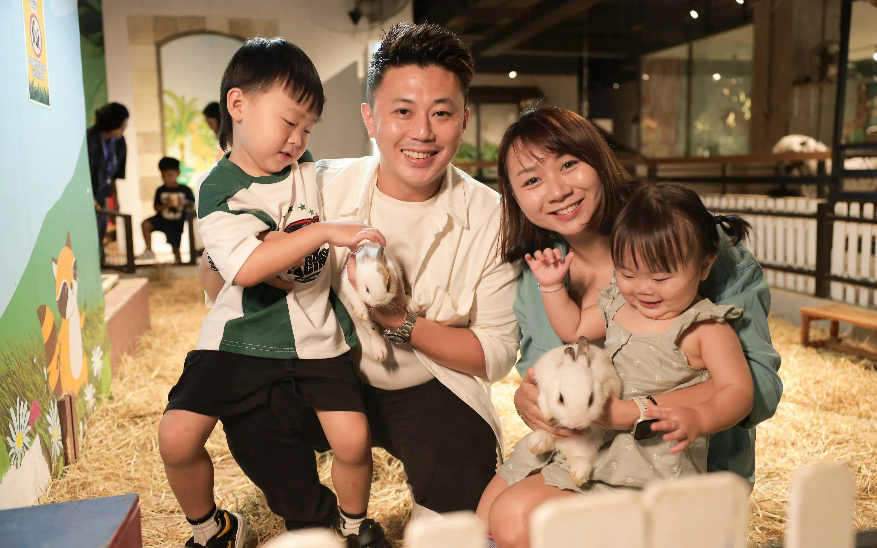 Family interacting with rabbits at Just Farm Indoor Zoo Kuala Lumpur.