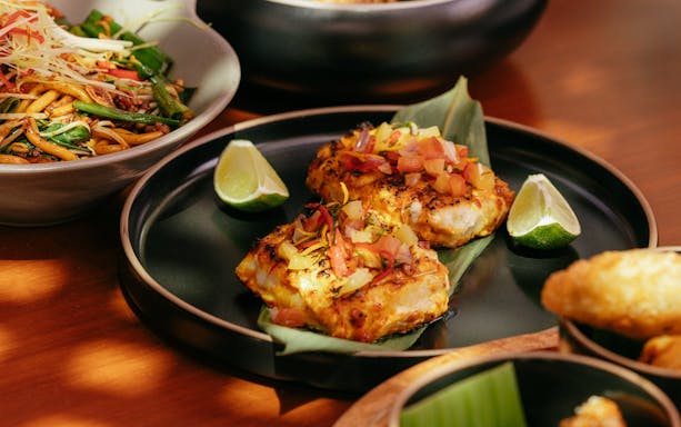 Grilled fish with diced vegetables and lime at Andaliman brunch, Dubai.