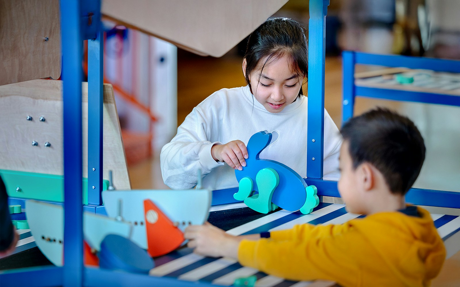 Children engaging with interactive exhibits at NEMO Science Museum, Amsterdam.