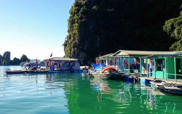 Floating village and boats in Halong Bay on Route 1 Small Group Dragonfly Cruise.