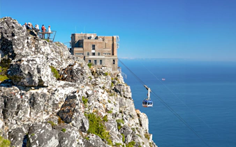 Cable car ascending Table Mountain with ocean view, Cape Town.