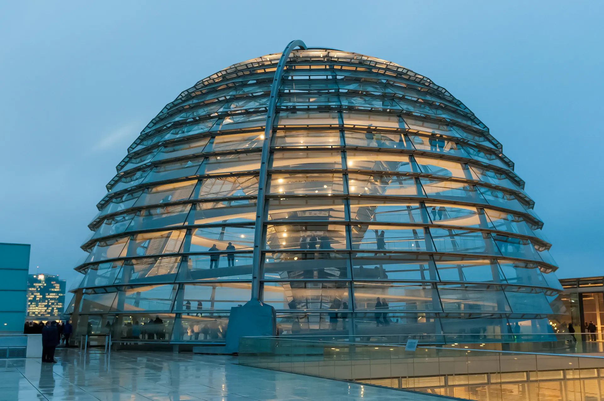 Reichstag Dome in Berlin at dusk, showcasing modern architecture and historical significance.