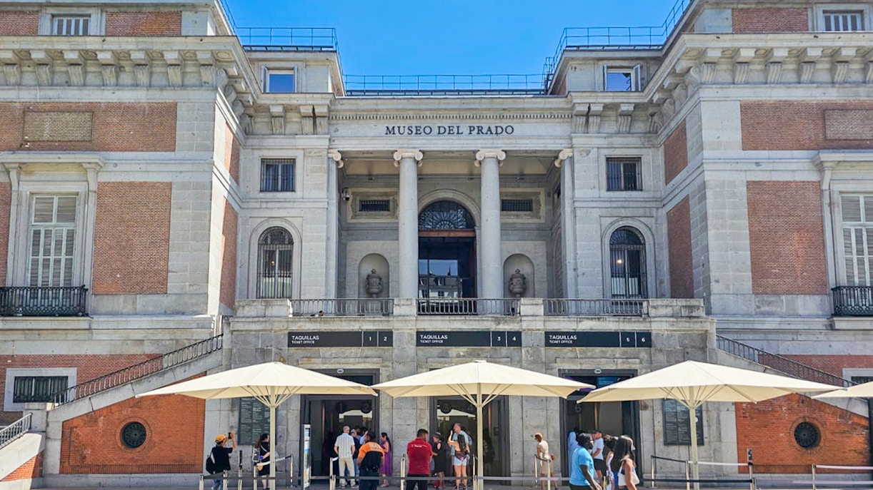 Visitors viewing art pieces inside Prado Museum, Madrid.