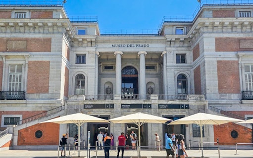 Prado Museum entrance with visitors in Madrid, Spain.