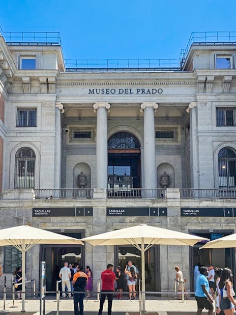 Prado Museum entrance with visitors in Madrid, Spain.